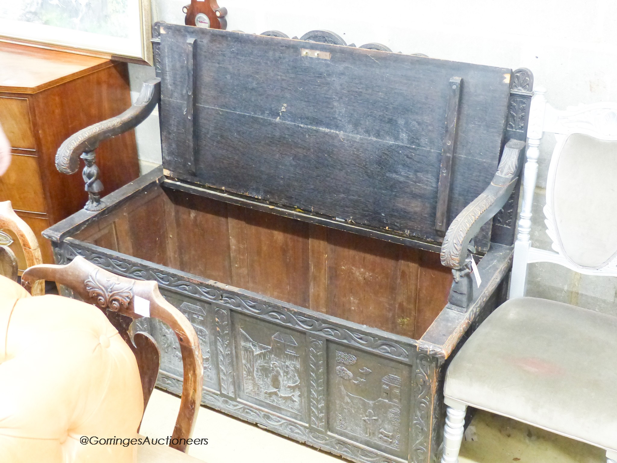 A late 19th century Flemish carved oak box seat settle, W.140cm D.62cm H.105cm